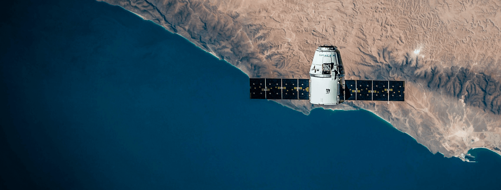 Aerial view of coastline with SpaceX spacecraft